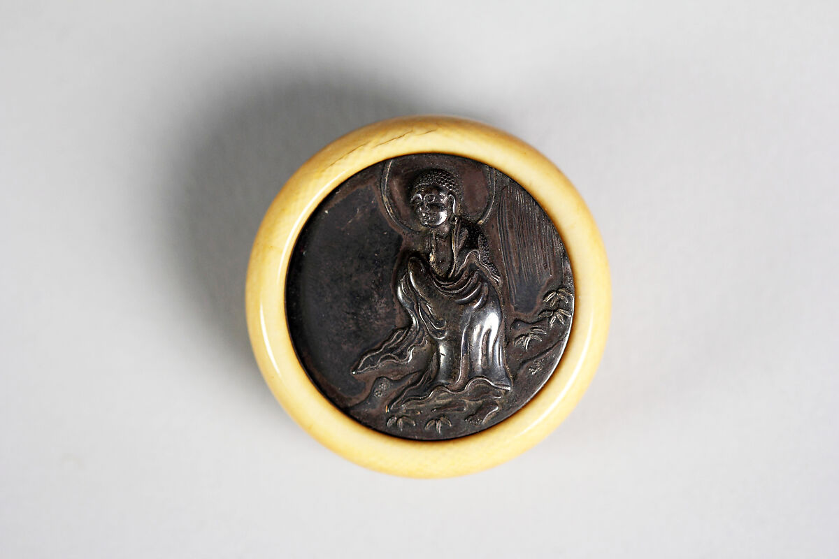 Netsuke of Shakyamuni Buddha, Ivory with bronze disk, Japan 