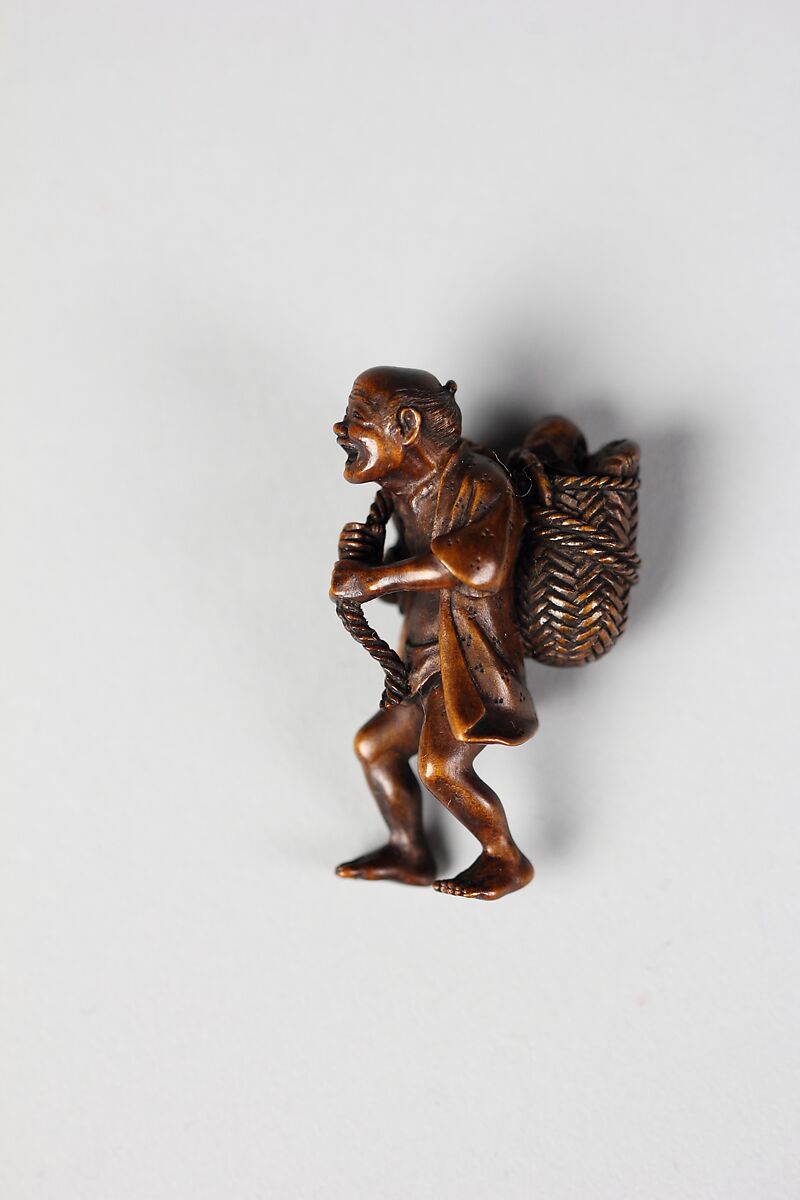 Netsuke of Man Carrying Basket of Fish, Wood, Japan 