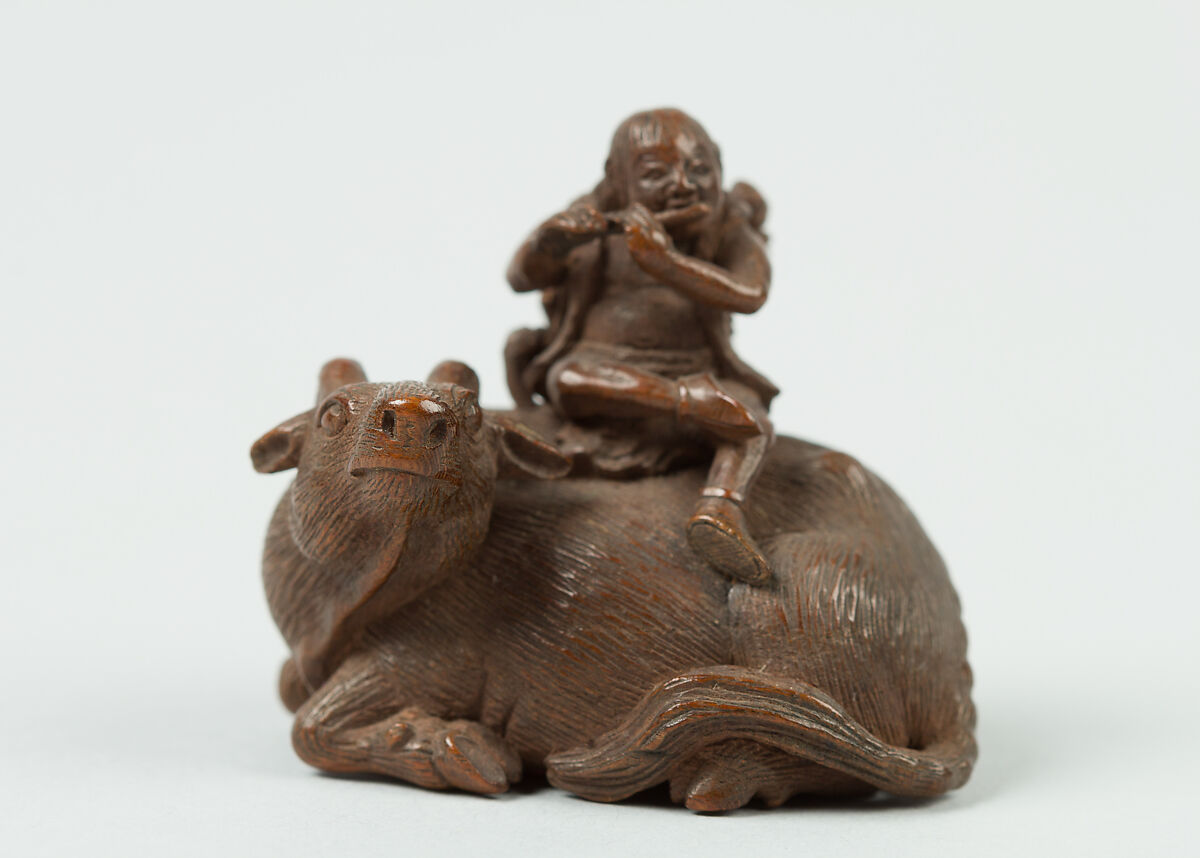 Netsuke of Man Playing Flute atop an Ox, Wood, Japan 