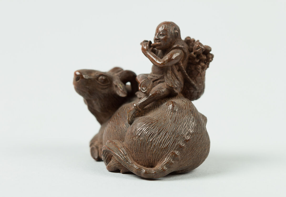 Netsuke of Man Playing Flute atop an Ox, Wood, Japan