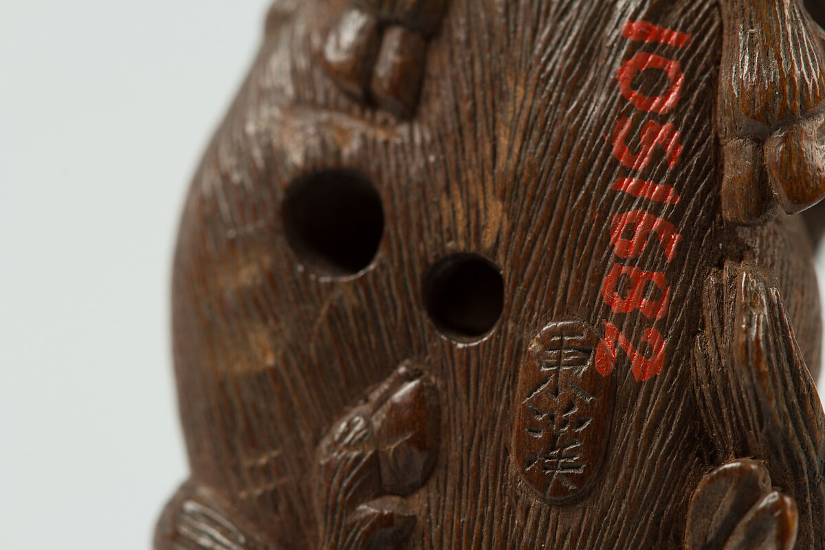 Netsuke of Man Playing Flute atop an Ox, Wood, Japan