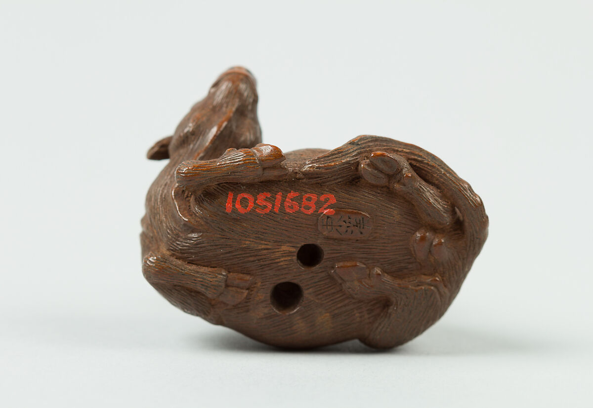 Netsuke of Man Playing Flute atop an Ox, Wood, Japan