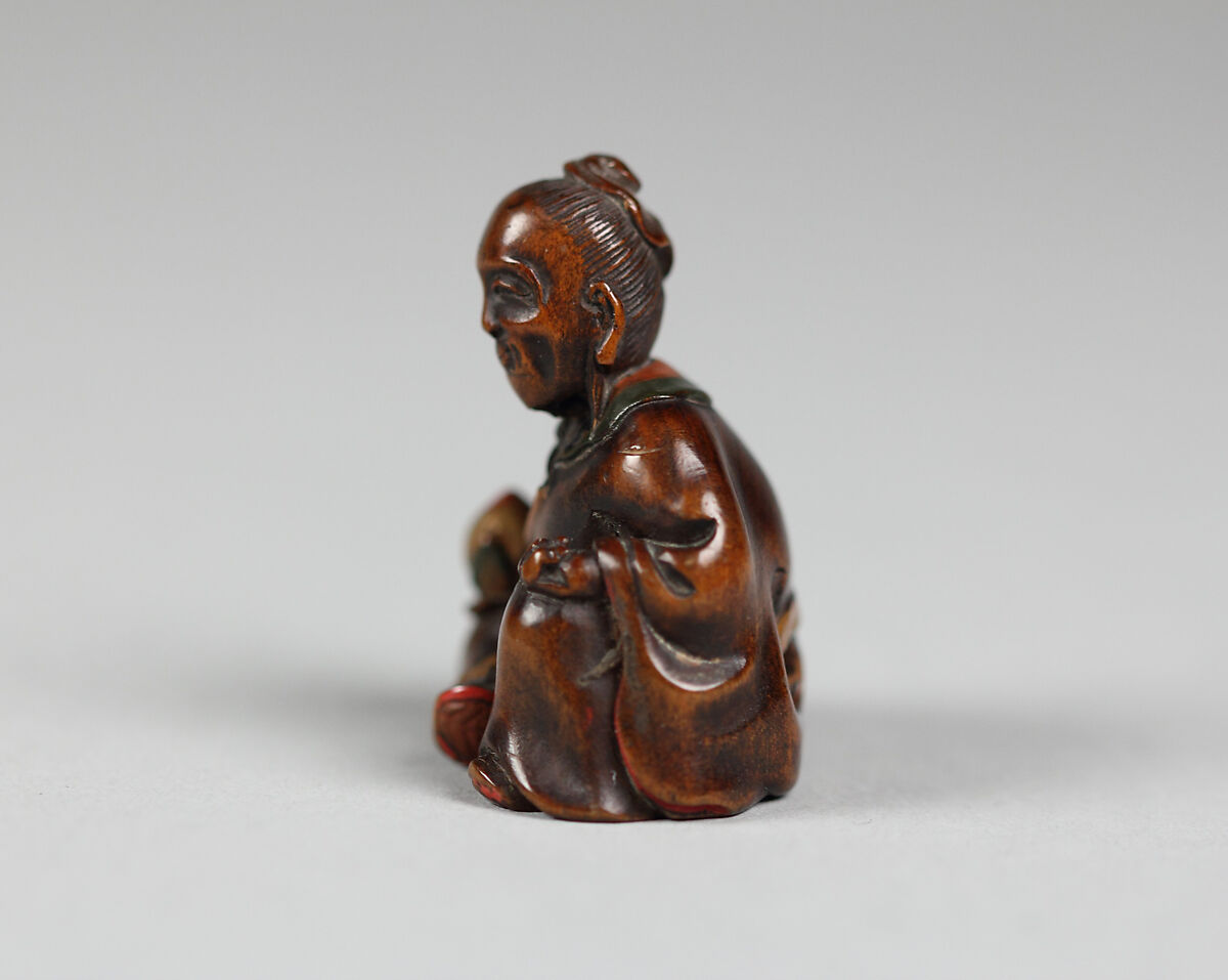 God of Longevity with a Peach, Wood; stained red in places, Japan