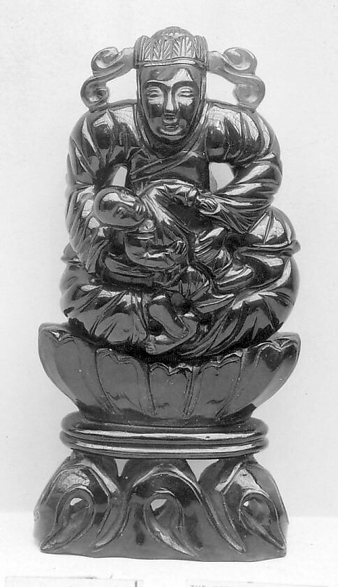 Seated Figure Holding a Child, Amber, China 