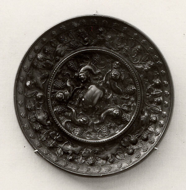 Mirror with fantastic animals amid grape vines, Bronze with black patina, China