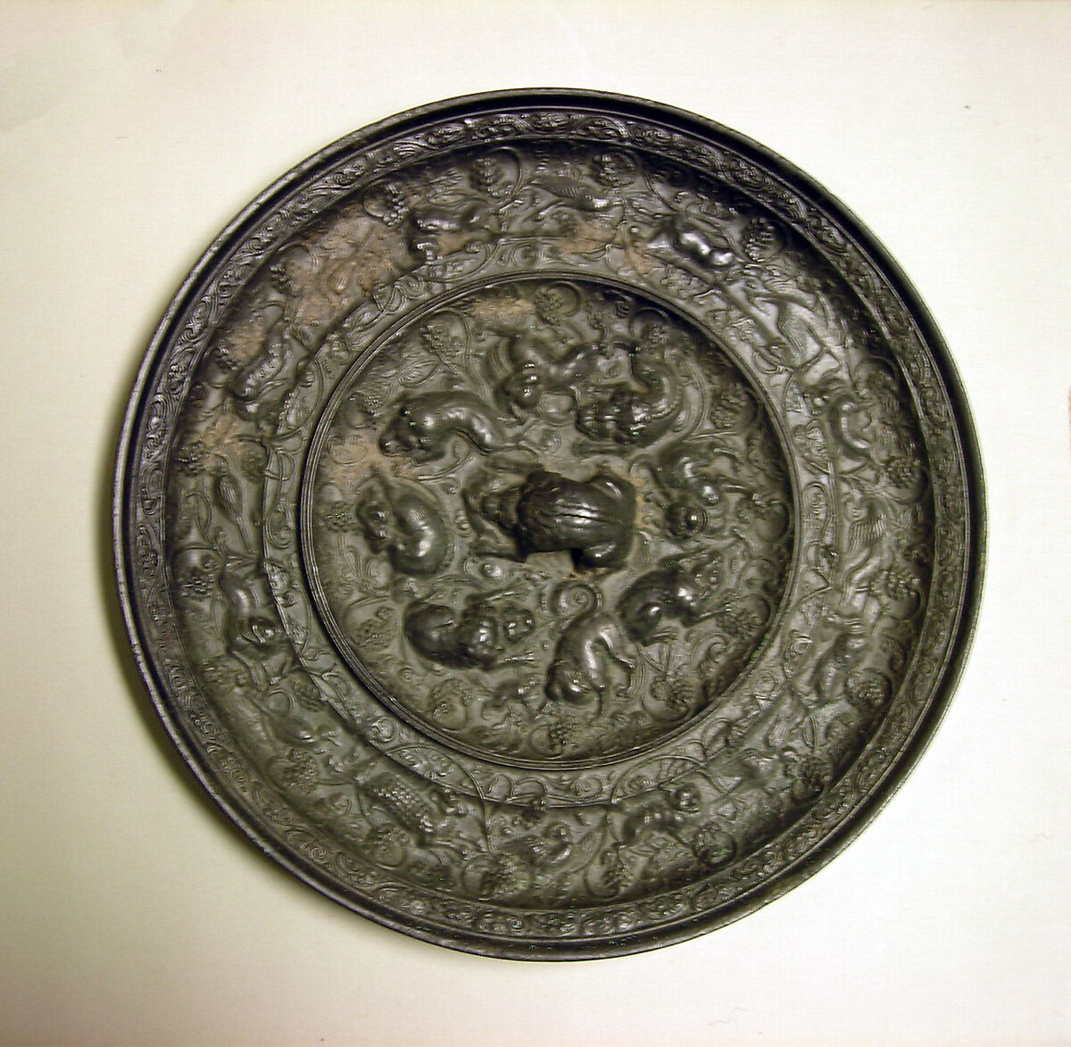 Mirror with fantastic animals amid grape vines, Bronze, China 