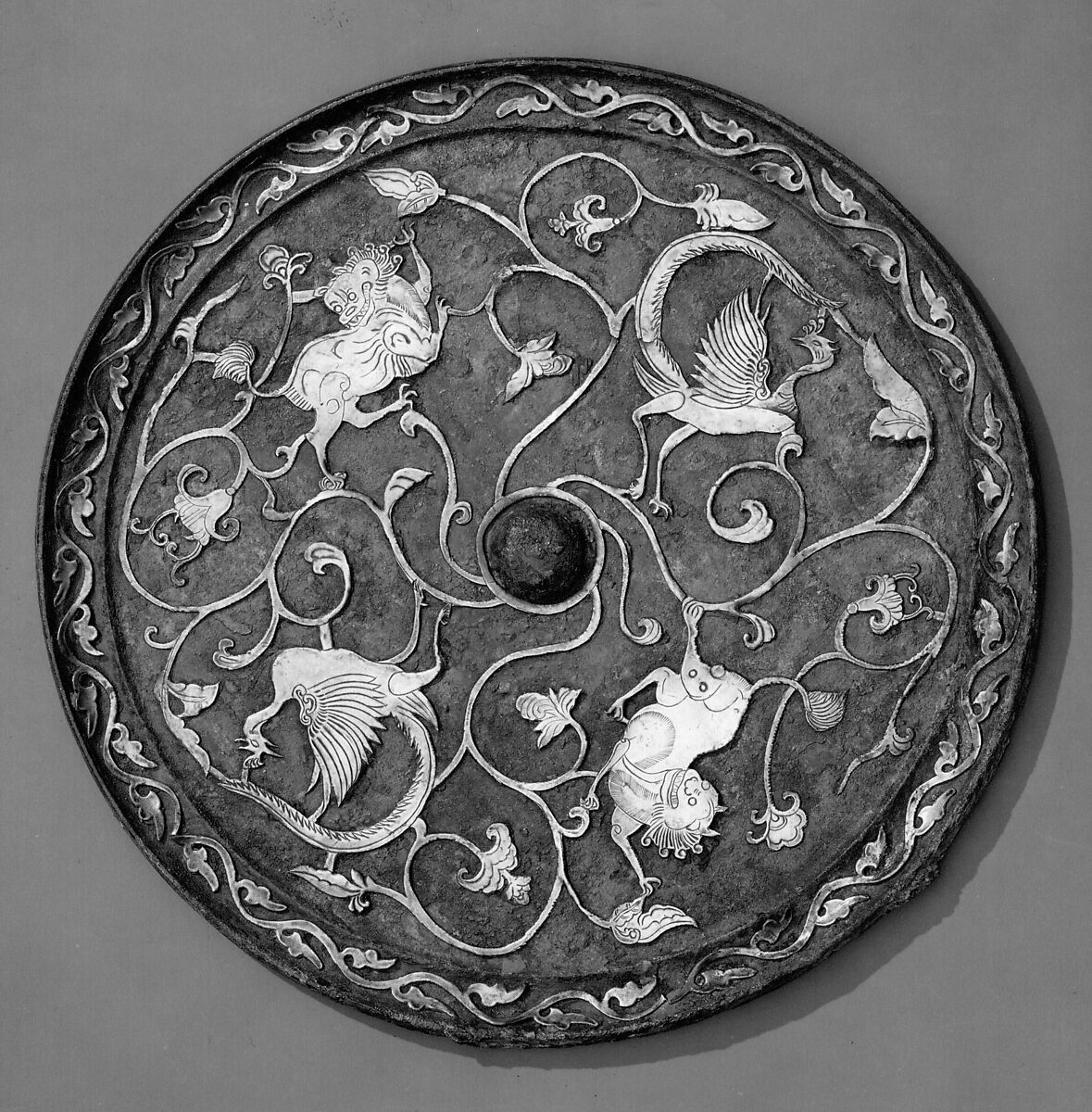 Mirror with birds and lions, Bronze with silver inllay, China
