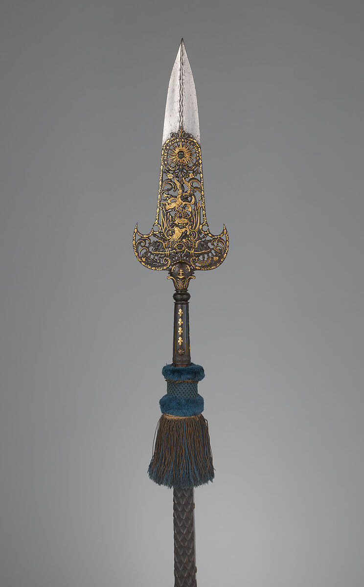 Three Partisans Carried by the Bodyguard of Louis XIV (1638–1715, reigned from 1643), 14.25.454 designed by Jean Berain (French, Saint-Mihiel 1640–1711 Paris), Steel, gold, wood, textile, brass, French, Paris