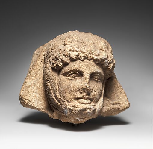 Limestone relief head of a Persian