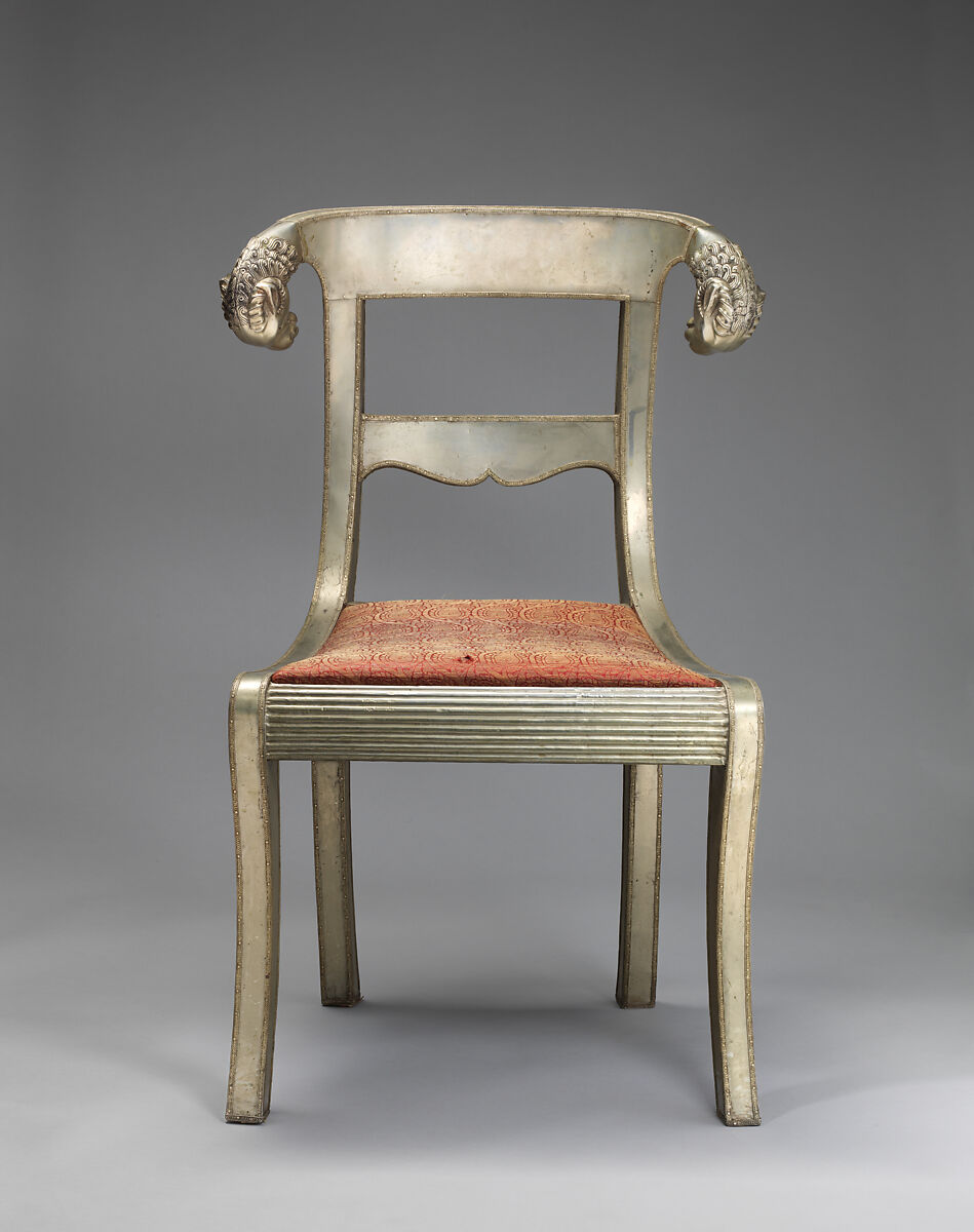 Side chair with rams' heads (one of a pair), White alloy metal sheets (silvered?) over wooden core, probaly teak; silk and metallic woven textile, Anglo-Indian 