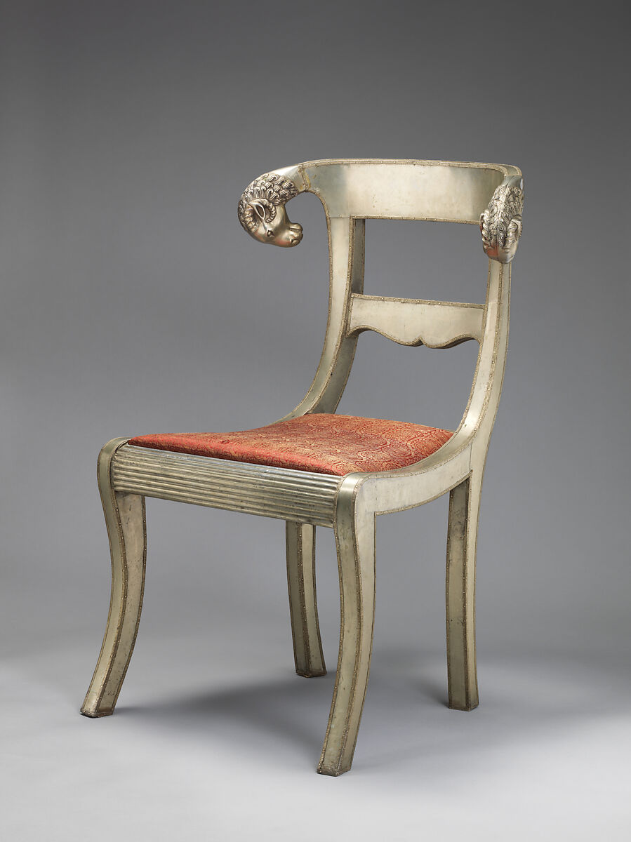 Side chair with rams' heads (one of a pair), White alloy metal sheets (silvered?) over wooden core, probaly teak; silk and metallic woven textile, Anglo-Indian
