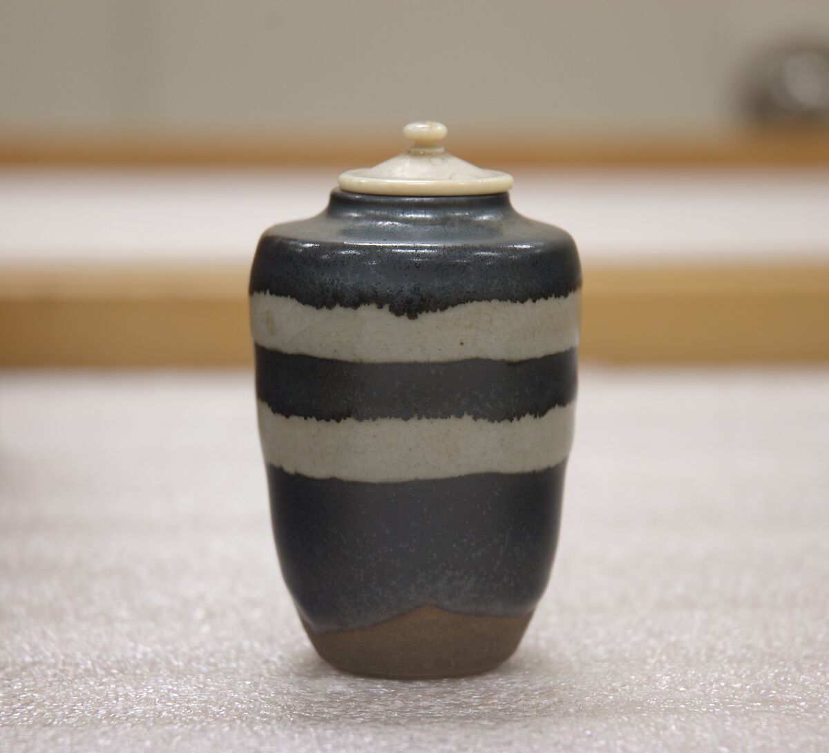 Tea jar, Nonomura Ninsei (Japanese, active ca. 1646–94), Clay; black glaze with two bands of crackled white glaze; (Awata ware), Japan 