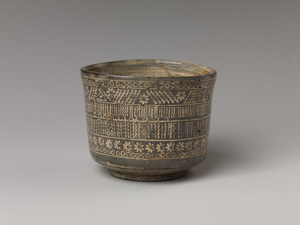 Tea bowl with decoration of chrysanthemums and wavy lines, Stoneware with stamped, white-slip design, Probably Korea
