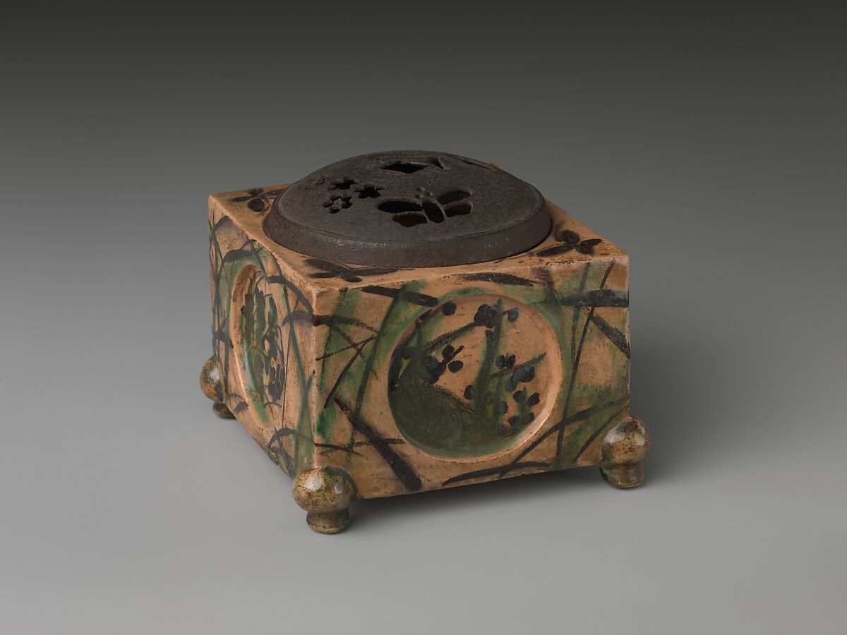 Incense Burner (kōro) with Design of Grasses, Cherry Blossoms and Butterflies, Hon&#39;ami Kōetsu (Japanese, 1558–1637), Clay; yellow glaze; decoration of flowers, grasses and butterflies; perforated iron cover (Kyoto ware), Japan 