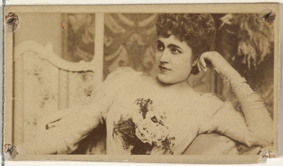 [Actress lounging while holding bouquet of flowers], from the Actors and Actresses series (N145-8) issued by Duke Sons & Co. to promote Duke Cigarettes, Issued by W. Duke, Sons &amp; Co. (New York and Durham, N.C.), Albumen photograph 