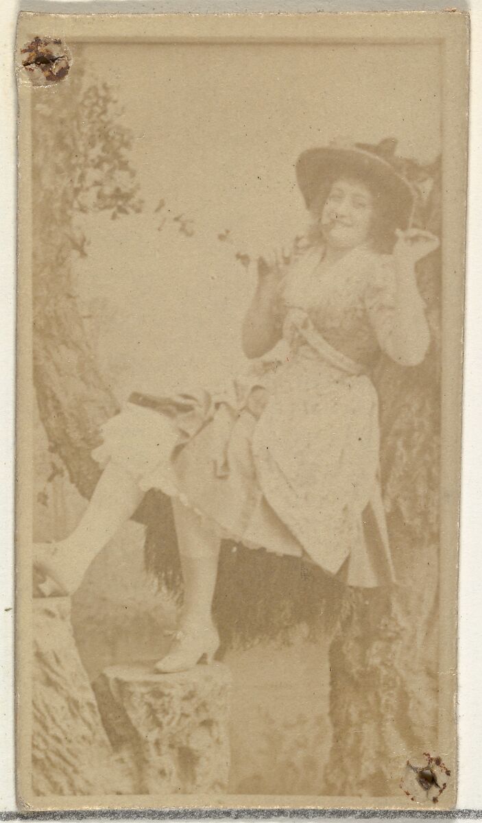 [Actress in studio reclining against prop trees], from the Actors and Actresses series (N145-8) issued by Duke Sons & Co. to promote Duke Cigarettes, Issued by W. Duke, Sons &amp; Co. (New York and Durham, N.C.), Albumen photograph 