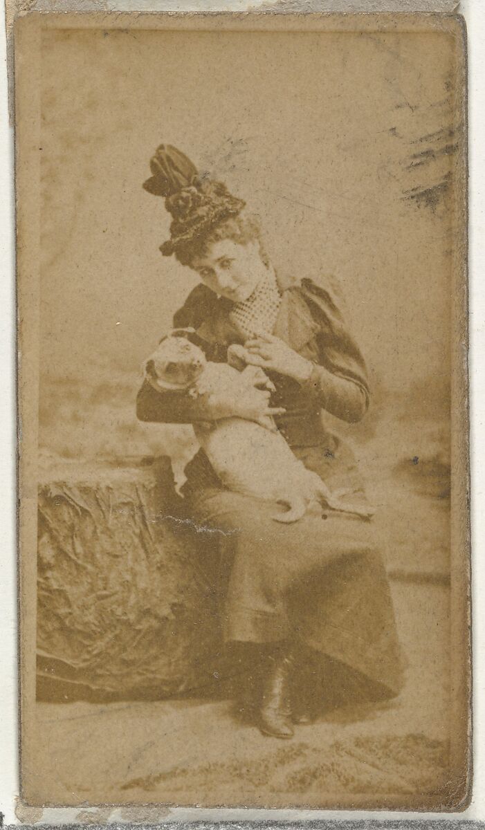 [Actress cradling small dog], from the Actors and Actresses series (N145-8) issued by Duke Sons & Co. to promote Duke Cigarettes, Issued by W. Duke, Sons &amp; Co. (New York and Durham, N.C.), Albumen photograph 