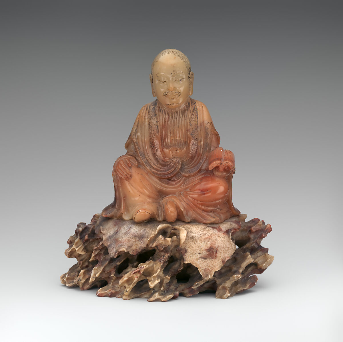 Seated luohan holding a book, Soapstone, China 