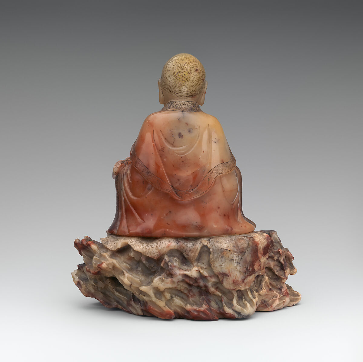 Seated luohan holding a book, Soapstone, China