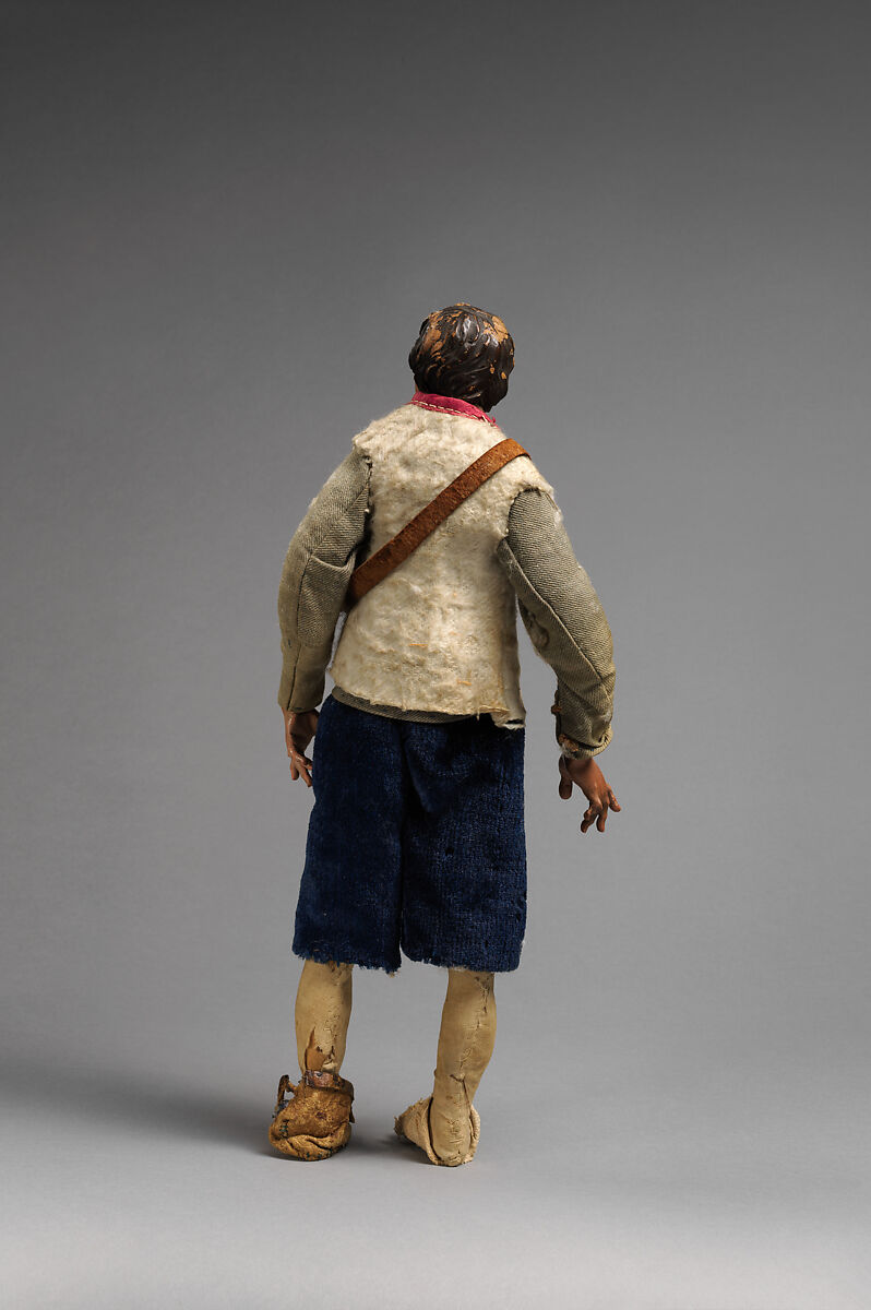 “Shepherd” looking up dressed in light green jacket, white furry vest, blue pants, leather bag, Mixed media, Italian