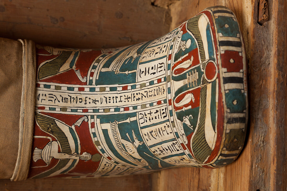 Mummy of Tasheriteniset with mummy mask and other cartonnage elements, also with garland of plants, Mummified human body, linen, mummification material, painted and gilded cartonnage, plant remains
