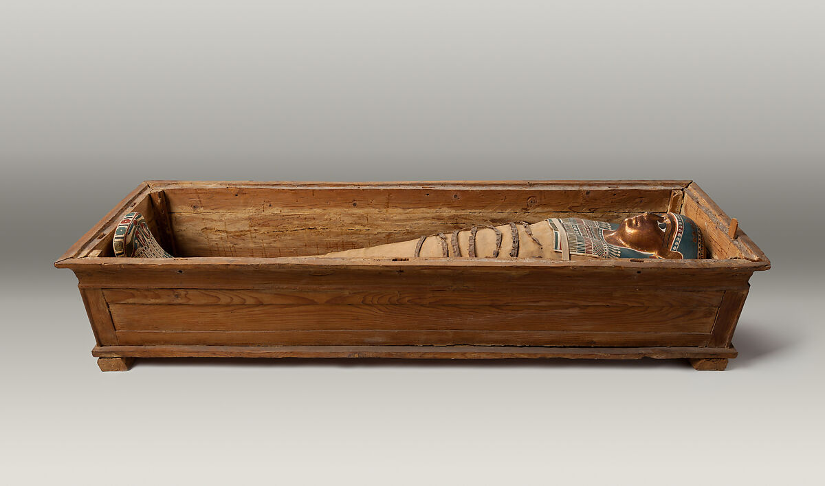 Mummy of Tasheriteniset with mummy mask and other cartonnage elements, also with garland of plants, Human Remains, linen, mummification material, painted and gilded cartonnage, plant remains 