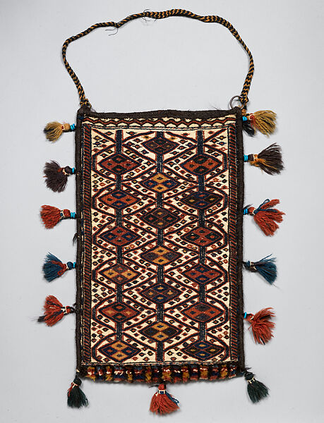 Spindle Bag, Wool (warp, sumak weft, pile, and tassels), cotton (ground weft and tassels), goat(?) hair (side finishes and tassels), metal rings, braided strap, and faience beads (tassels); weft-faced plain weave with pattern in sumak extra-weft wrapping (front and back); symmetrically knotted pile (bottom edge) 