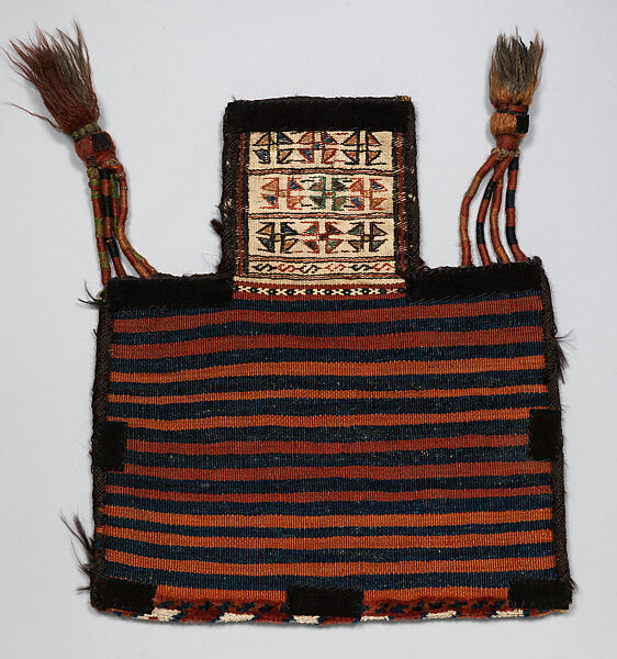Salt Bag, Wool (warp, ground weft, sumak weft, and pile), cotton (white sumak weft and white pile), and goat(?) hair (side finishes); sumak extra-weft wrapping (front); symmetrically knotted pile (bottom edge); weft-faced plain weave with pattern in sumak extra-weft wrapping (back); wrapped warp tassels