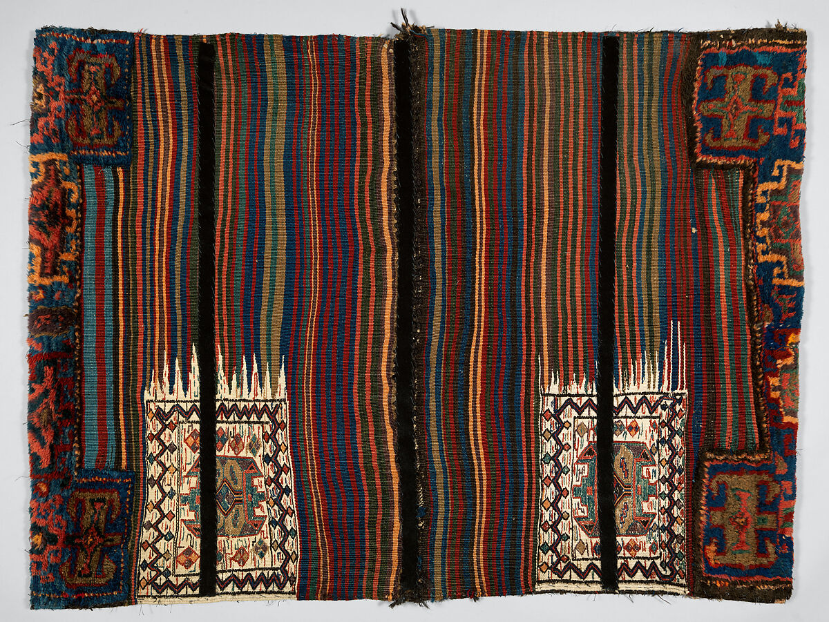 Double Flour Bag, Wool (warp, ground weft, sumak weft, and pile) and goat(?) hair (braided loops); sumak extra-weft wrapping, tapestry (kilim) with dovetailing, and border pattern in complementary weft weave (front); symmetrically knotted pile (top and bottom edges); weft-faced plain weave with two areas of pattern in sumak extra-weft wrapping with twined and braided loop closures (back)