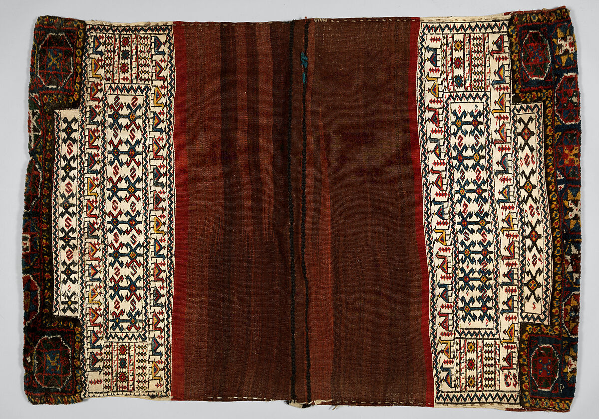 Double Flour Bag, Wool (warp, sumak weft, and pile), cotton (ground weft), and goat(?) hair (braided loops); weft-faced plain weave with pattern in sumak extra-weft wrapping (front); symmetrically knotted pile (top and bottom edges); weft-faced plain weave with pattern in sumak extra-weft wrapping and twined and braided loop closures (back)