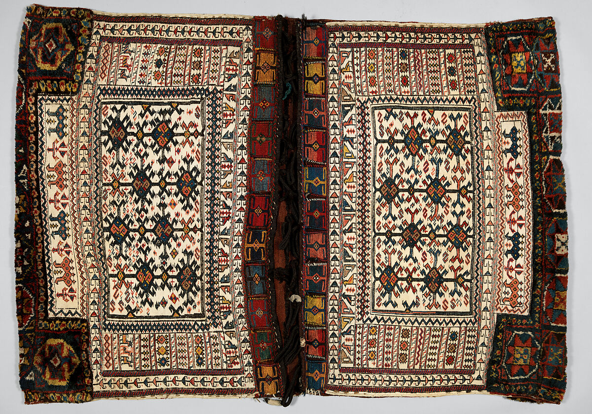 Double Flour Bag, Wool (warp, sumak weft, and pile), cotton (ground weft), and goat(?) hair (braided loops); weft-faced plain weave with pattern in sumak extra-weft wrapping (front); symmetrically knotted pile (top and bottom edges); weft-faced plain weave with pattern in sumak extra-weft wrapping and twined and braided loop closures (back) 