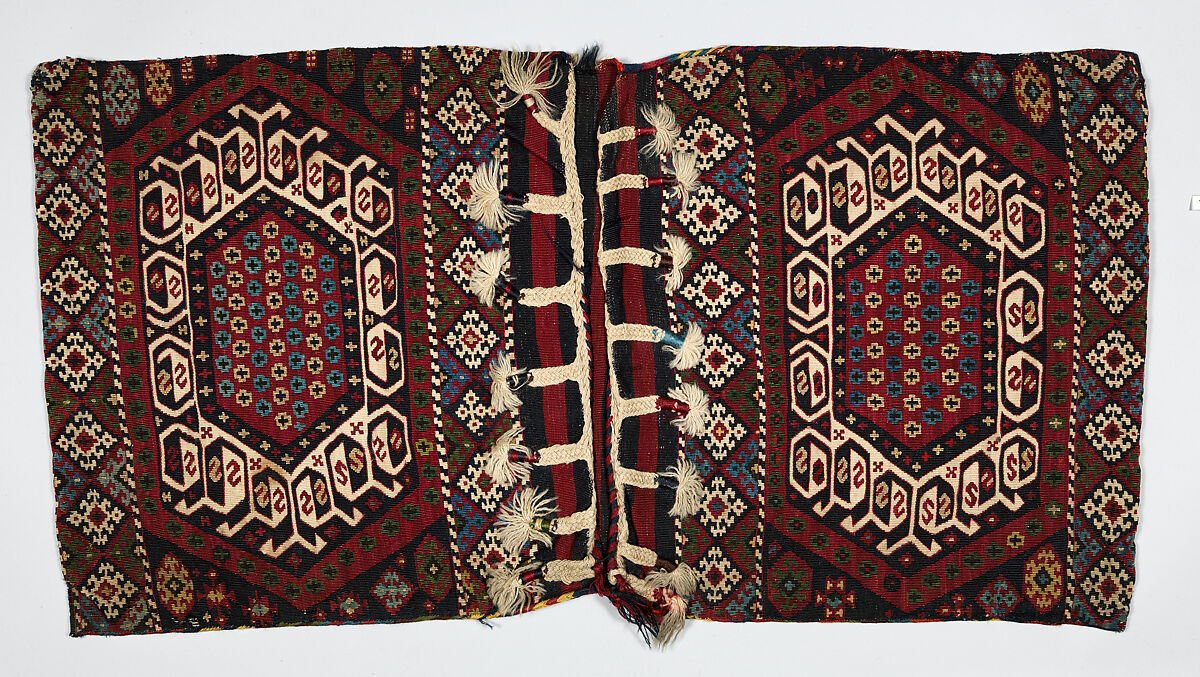 Double Saddle Bag (Heybe), Wool (warp and weft); copper coated with brass metal strip wrapped around cotton core (weft); slit tapestry (kilim), weft-faced plain weave, diagonal ridge sumak outline, closure in oblique plaiting, and plaited warp fringe (front); weft-faced plain weave (back) 