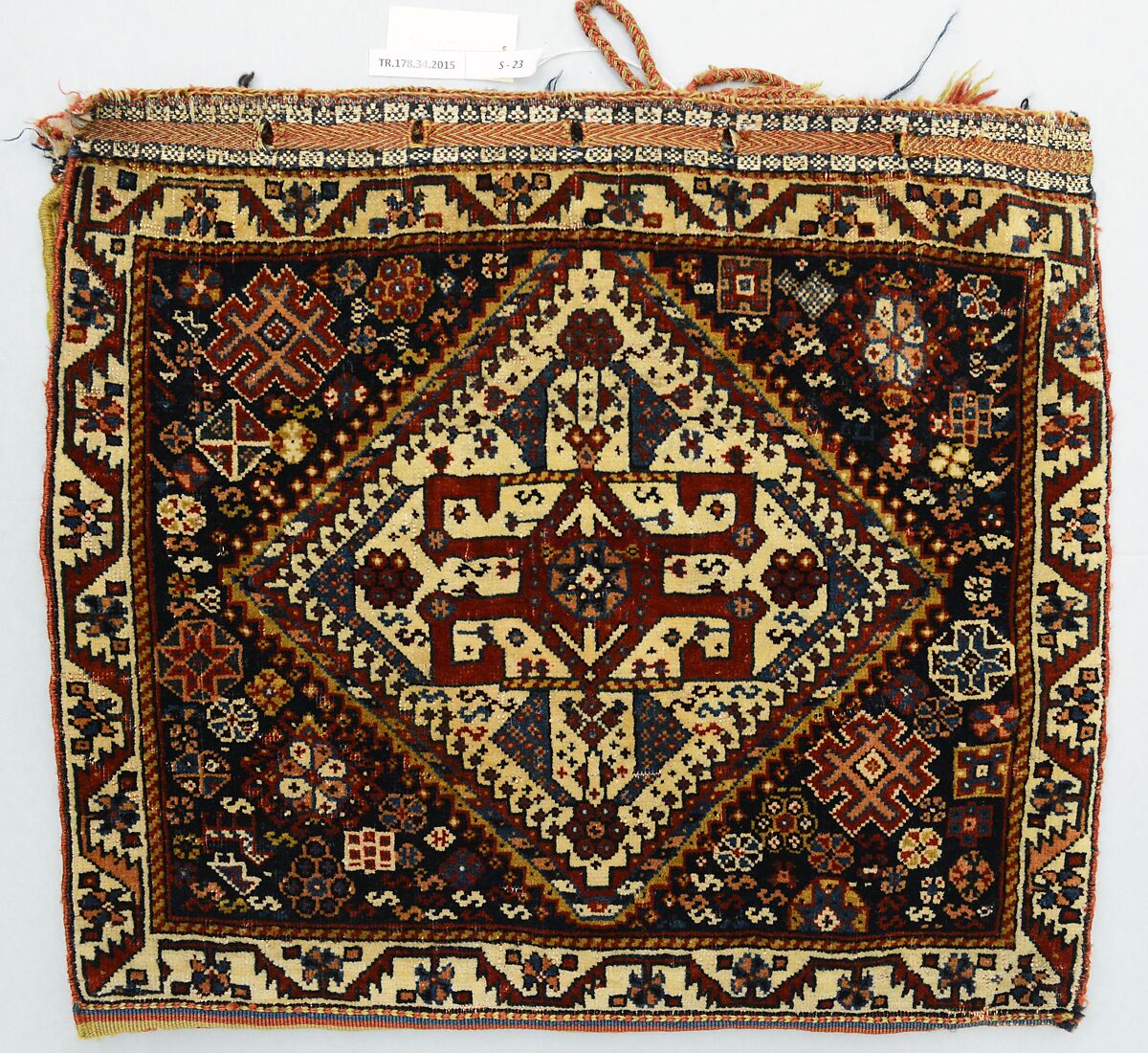 Half a Double Saddle Bag (Khorjin), Wool (warp, ground weft, and pile); asymmetrically knotted pile and closure border in complementary weft weave (front); slit tapestry (kilim) with border pattern in complementary weft weave, and twined and braided loop closures (back)