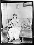 Woman on a Rattan Sofa, Indoors