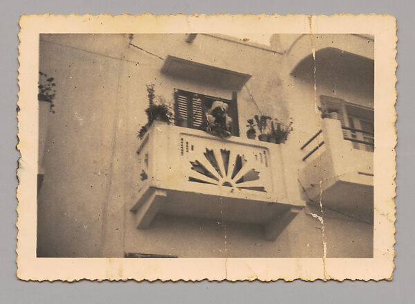 Woman Leaning over a Balcony