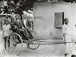 Two dapper young men in pull cart