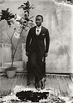 Young man in cravat with potted plant, Alex Agbaglo Acolatse (Togolese, Kedzi 1880–1975 Lomé), Glass, emulsion 