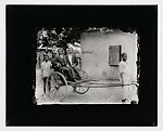 Two dapper young men in pull cart