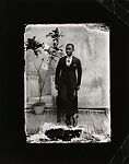 Young man in cravat with potted plant