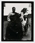 Family portrait with one boy and father in Kente cloth