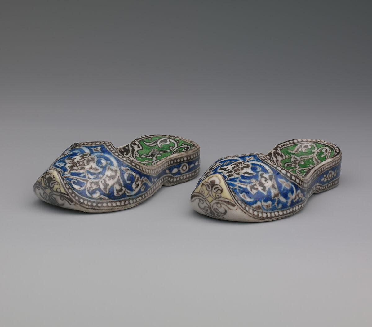 Pair of Qajar Ceramic Slippers, Stonepaste; underglaze painted under transparent glaze 