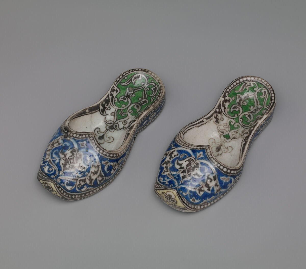 Pair of Qajar Ceramic Slippers, Stonepaste; underglaze painted under transparent glaze