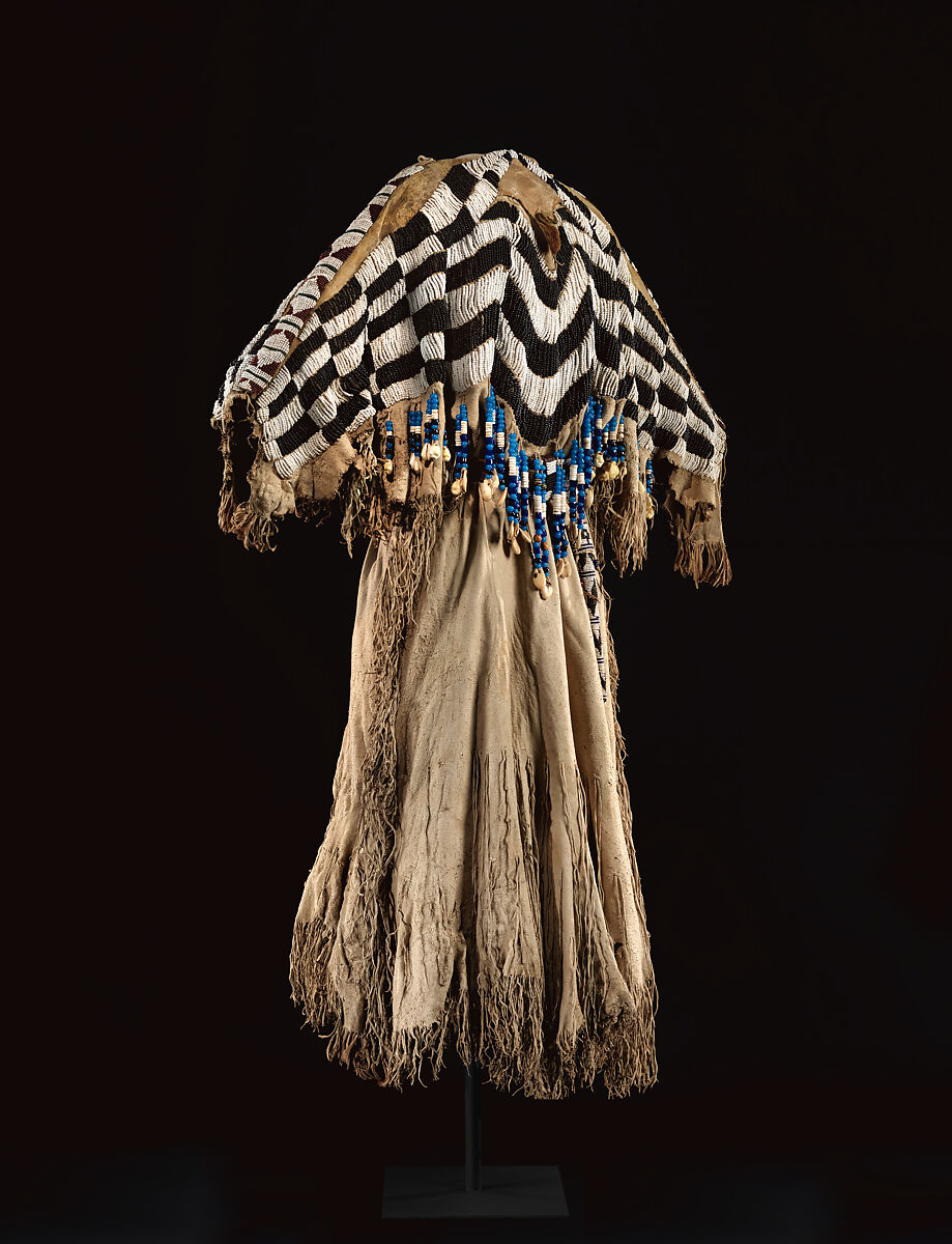 Dress and belt with awl case, Dress: tanned leather, glass beads, shell, bone, elk teeth, and brass thimbles
belt: commercial leather, glass beads, and metal studs
awl case: tanned leather, and glass beads, Wasco, Native American