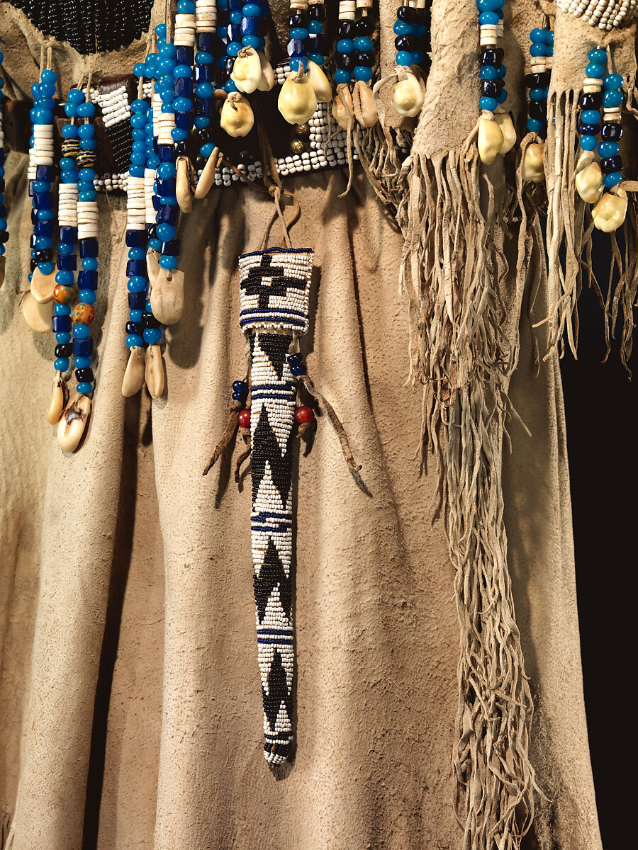 Dress and belt with awl case, Dress: tanned leather, glass beads, shell, bone, elk teeth, and brass thimbles
belt: commercial leather, glass beads, and metal studs
awl case: tanned leather, and glass beads, Wasco, Native American
