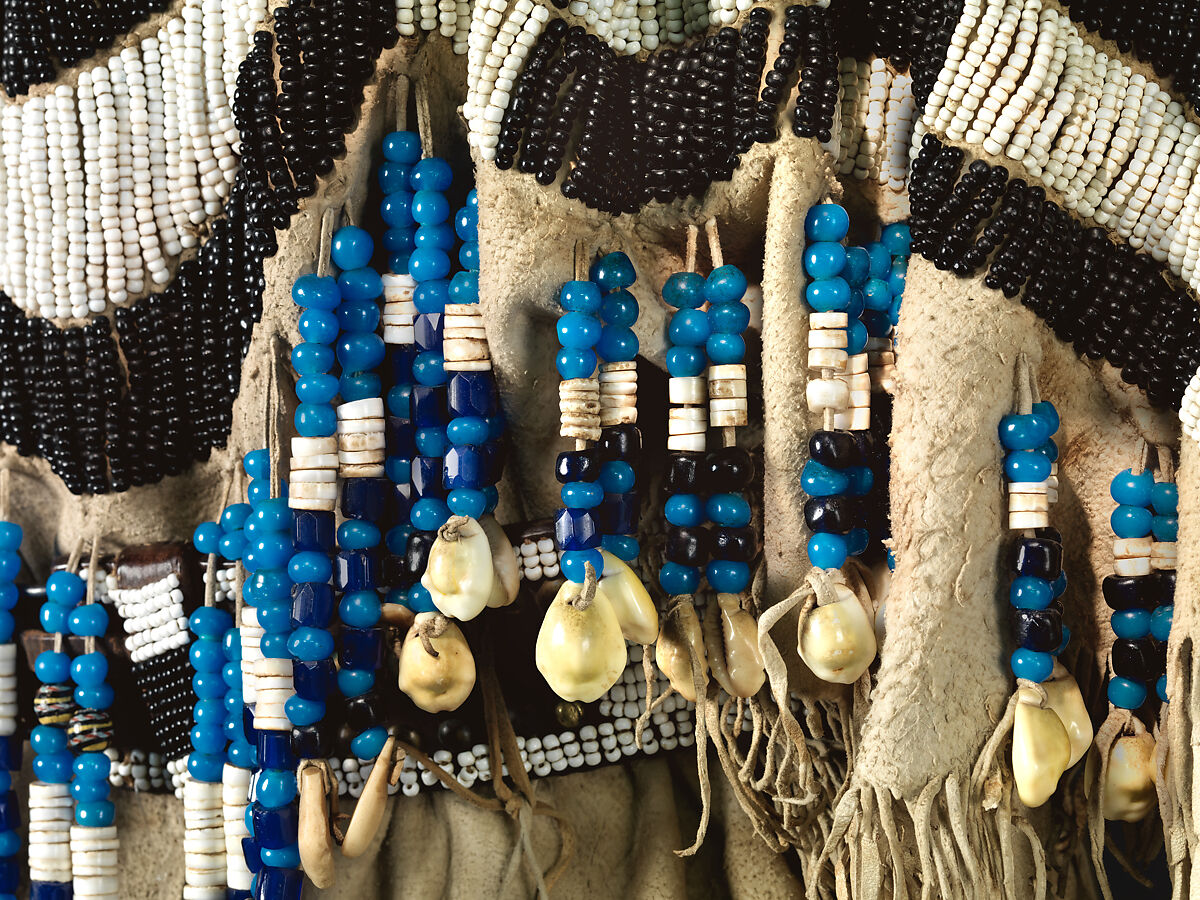 Dress and belt with awl case, Dress: tanned leather, glass beads, shell, bone, elk teeth, and brass thimbles
belt: commercial leather, glass beads, and metal studs
awl case: tanned leather, and glass beads, Wasco, Native American