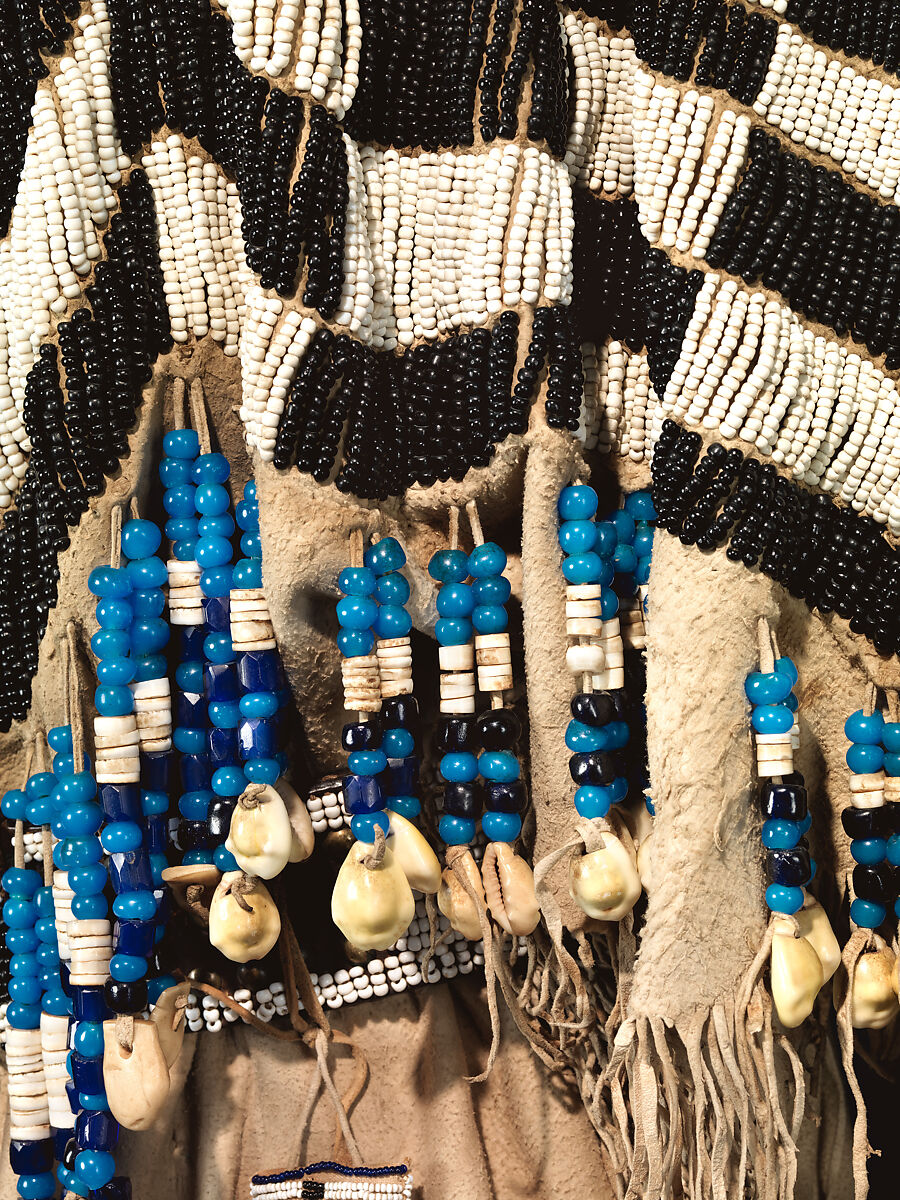 Dress and belt with awl case, Dress: tanned leather, glass beads, shell, bone, elk teeth, and brass thimbles
belt: commercial leather, glass beads, and metal studs
awl case: tanned leather, and glass beads, Wasco, Native American