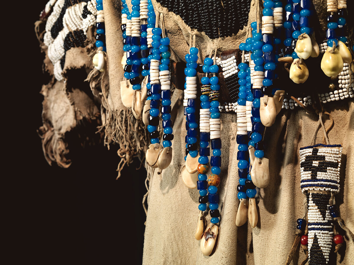 Dress and belt with awl case, Dress: tanned leather, glass beads, shell, bone, elk teeth, and brass thimbles
belt: commercial leather, glass beads, and metal studs
awl case: tanned leather, and glass beads, Wasco, Native American
