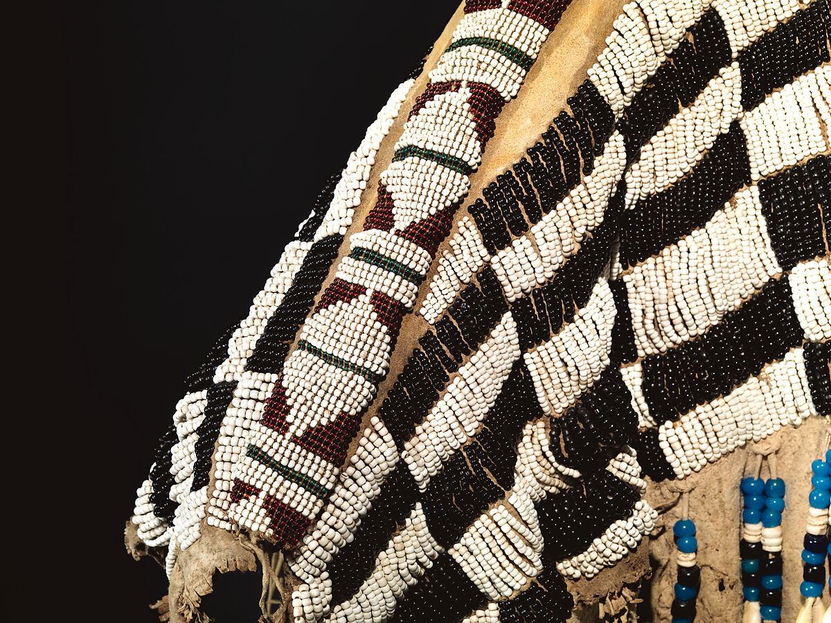 Dress and belt with awl case, Dress: tanned leather, glass beads, shell, bone, elk teeth, and brass thimbles
belt: commercial leather, glass beads, and metal studs
awl case: tanned leather, and glass beads, Wasco, Native American