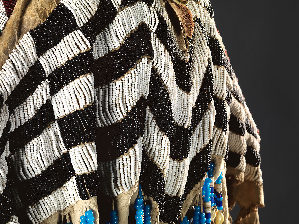 Dress and belt with awl case, Dress: tanned leather, glass beads, shell, bone, elk teeth, and brass thimbles
belt: commercial leather, glass beads, and metal studs
awl case: tanned leather, and glass beads, Wasco, Native American