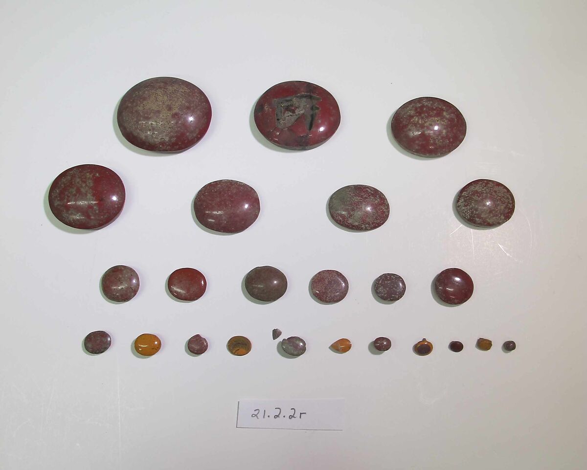 Inlays from shrine: rounded discs, one with cell for a wedjat, Glass